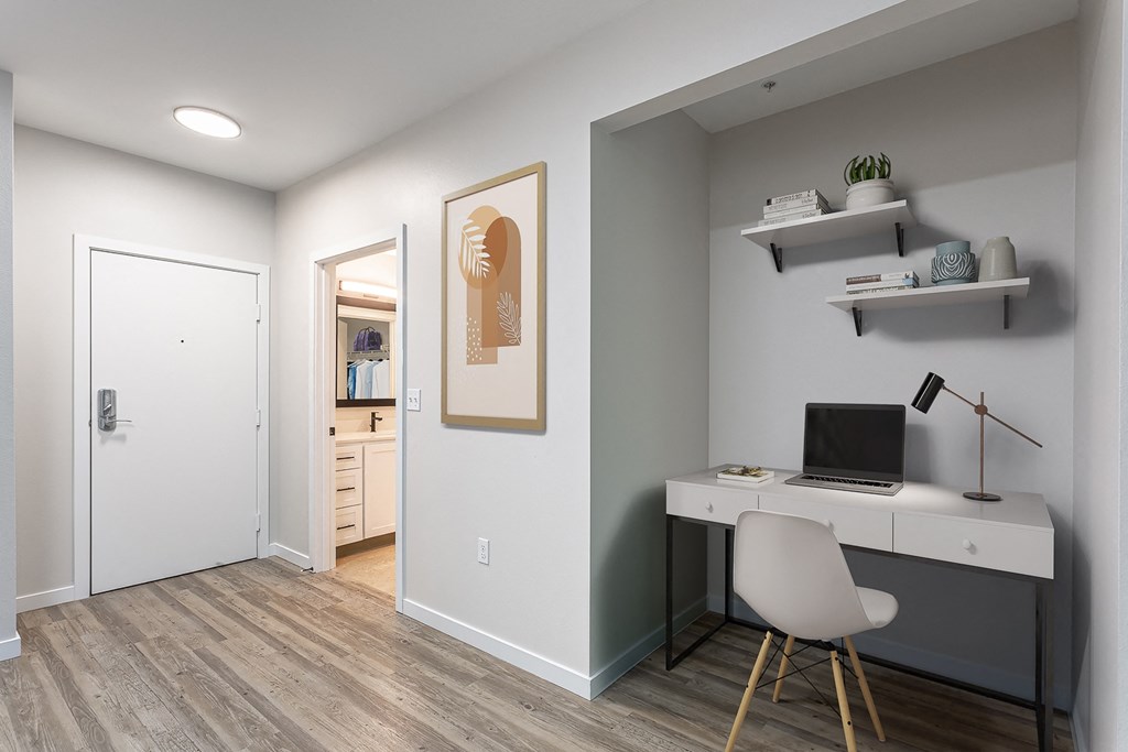 a home office with a white desk and a white chair