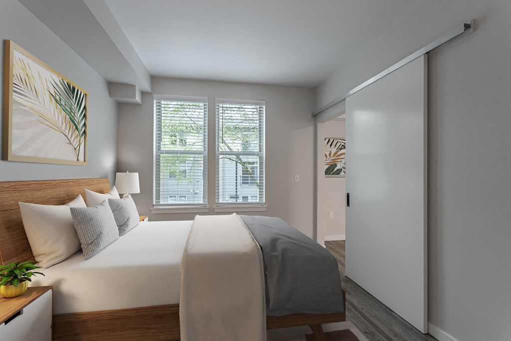 a bedroom with a large bed and a large window