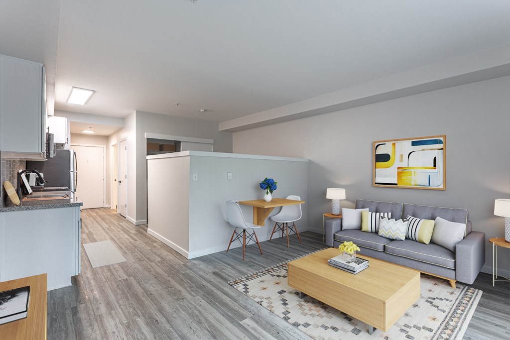 a living room with a gray couch and a wooden coffee table