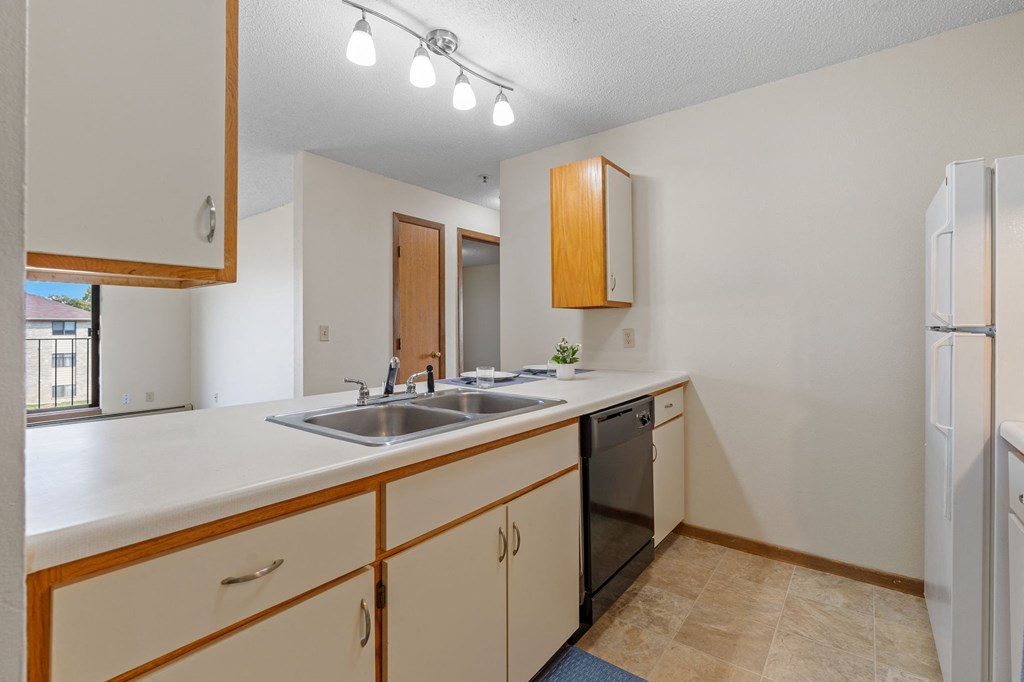 the preserve at ballantyne commons apartment kitchen with sink and refrigerator