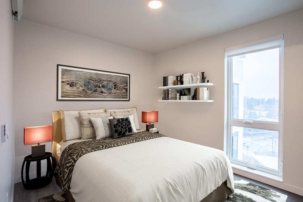 a bedroom with a large bed and a window