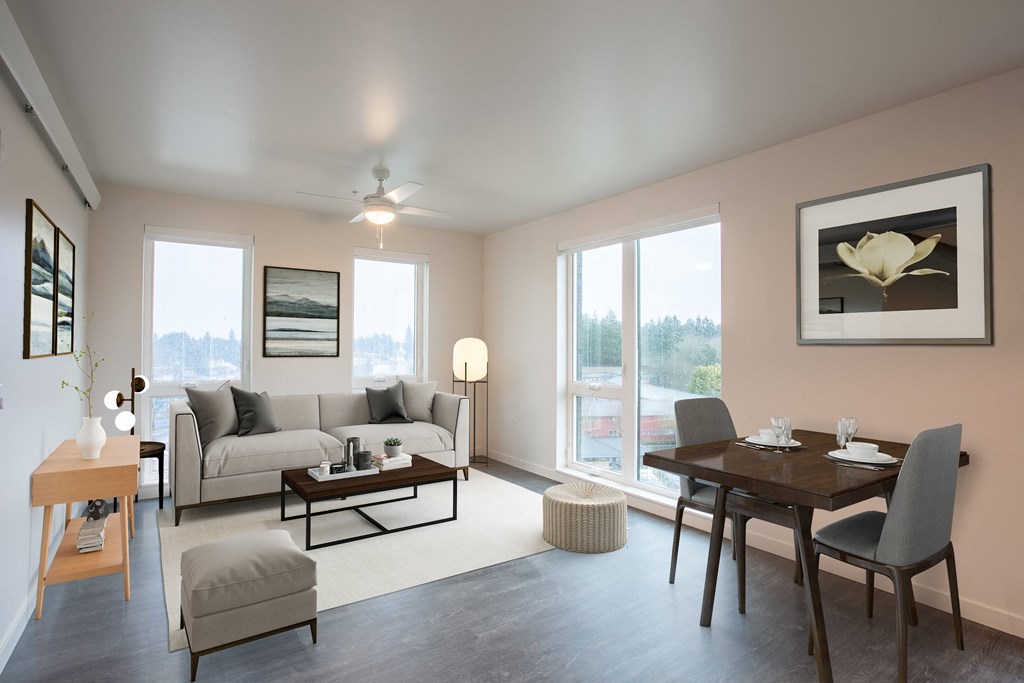 a living room with a couch and a table and a window