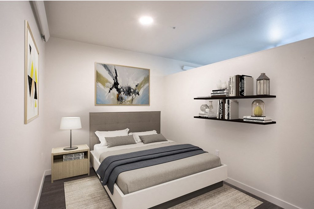 a bedroom with a bed and a painting on the wall