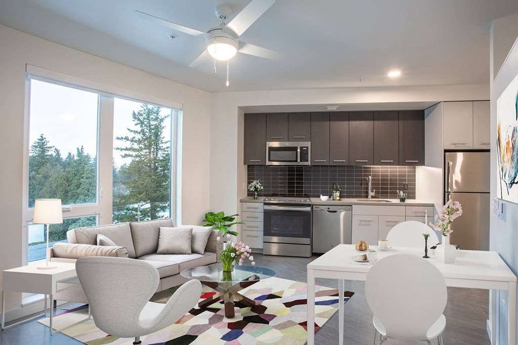 a living room and kitchen with a couch and a table