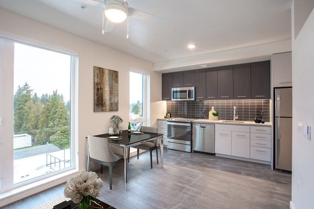a kitchen and dining room with a large window