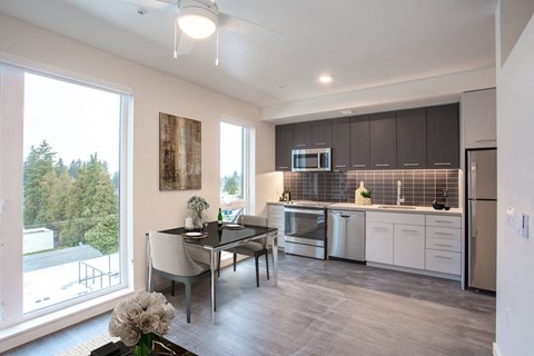 a kitchen and dining room with a large window