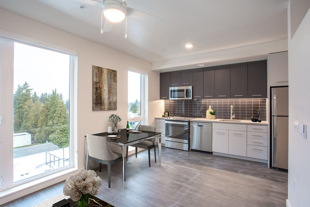 a kitchen and dining room with a large window and