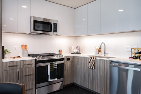 A modern kitchen with a stainless steel oven and microwave.