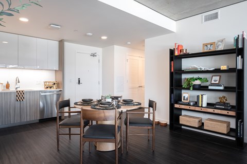 A modern dining room with a wooden table and chairs.