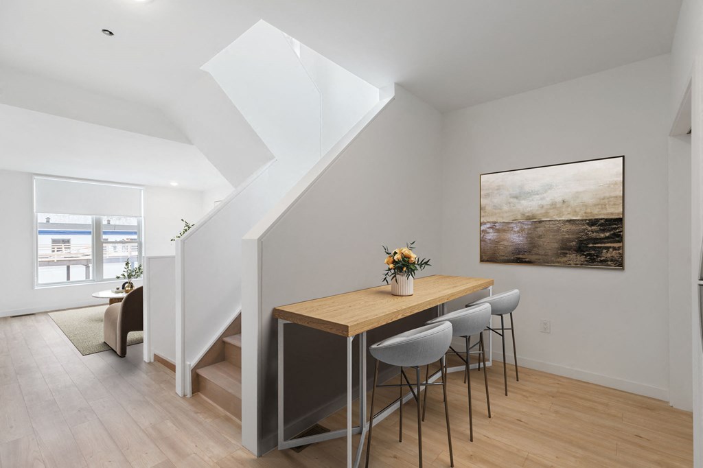Contemporary kitchen design with white upper cabinets, dark lower cabinets, and a vibrant teal tile backsplash above the countertops.