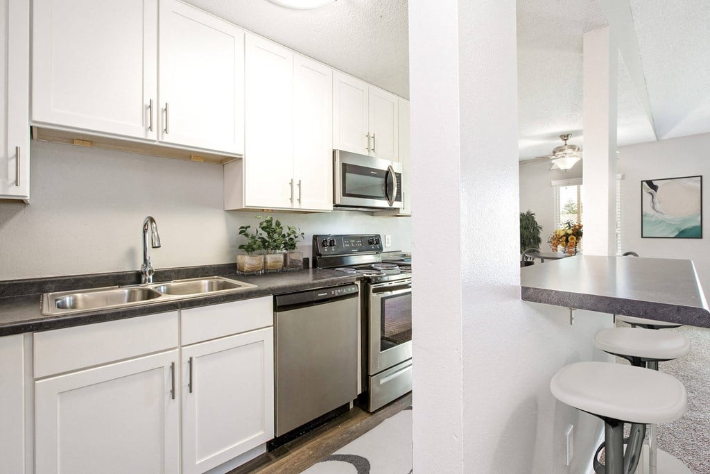 Hinton Height_Cottage Grove_MN_a kitchen with stainless steel appliances and white cabinets