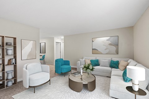 A living room with a white couch, blue chair, and a coffee table.