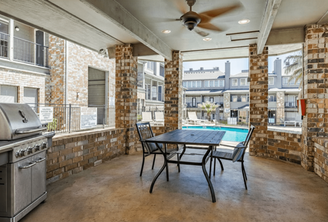 A patio with a table and chairs and a pool table.