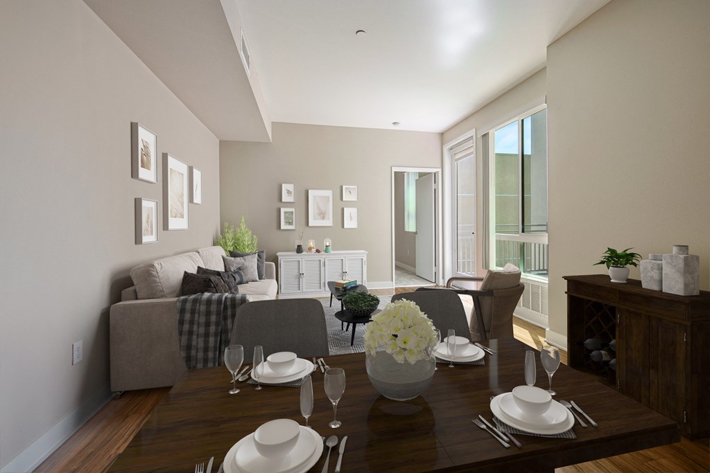 A dining room with a table set for a meal.