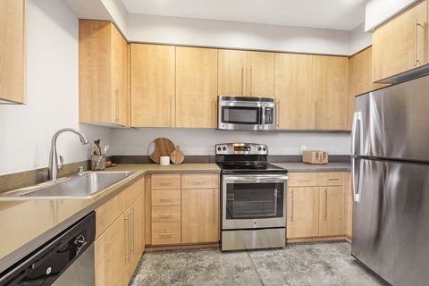 a kitchen with wooden cabinets and stainless steel appliances