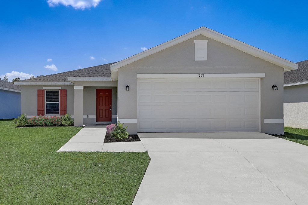 House with a spacious yard at The Groves at Lake Ella in Lady Lake, Florida, a pet-friendly rental community.
