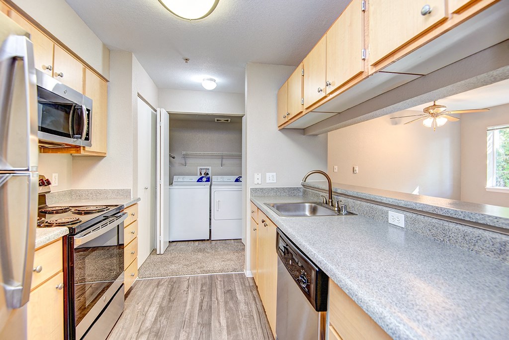 a kitchen with granite countertops and stainless steel appliances