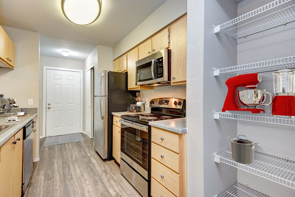 a kitchen with wooden cabinets and stainless steel appliances