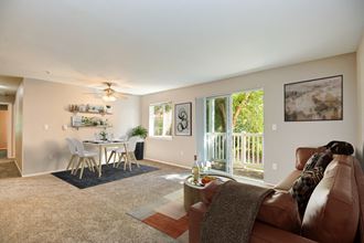 Two Bedroom Apartments in Lacey WA - The Village at Union Mills - Spacious Living Room with Plush Carpeting, Window, and Access to the Balcony