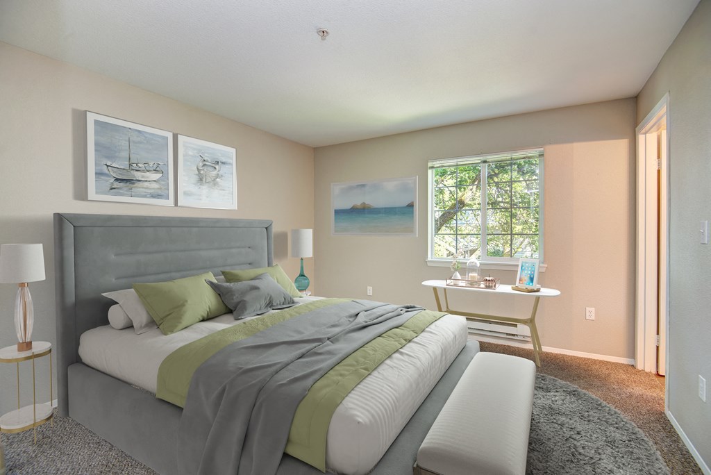 Three Bedroom Apartments in Lacey WA - The Village at Union Mills - Bedroom with Full-Sized Bed, Carpetted Floor, Nightstands, Window, and Wall Art