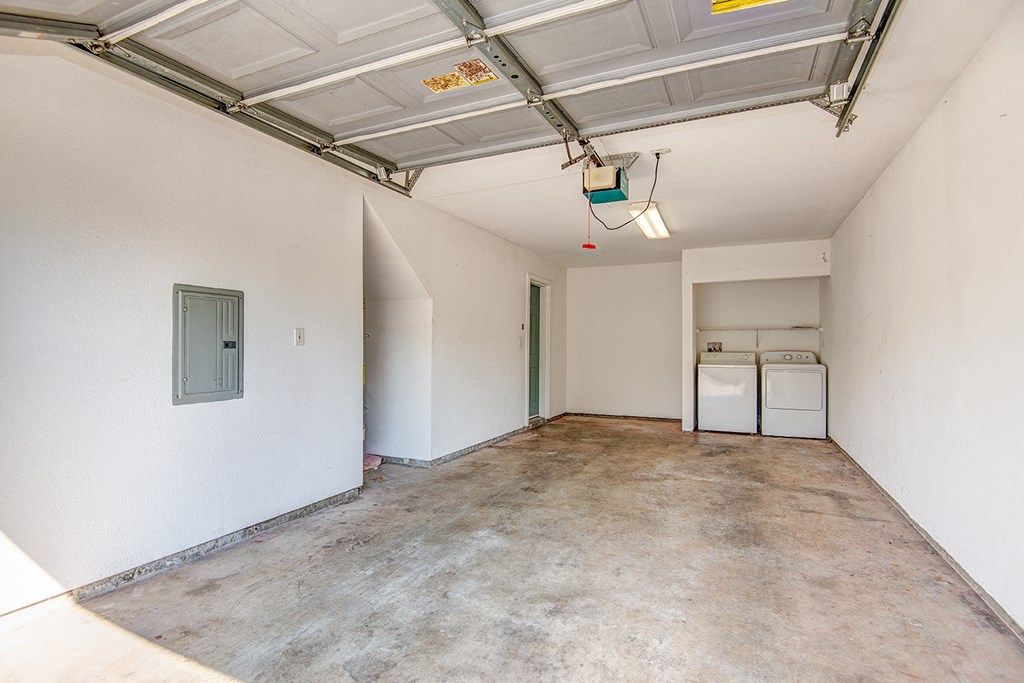 an empty room with white walls and a concrete floor