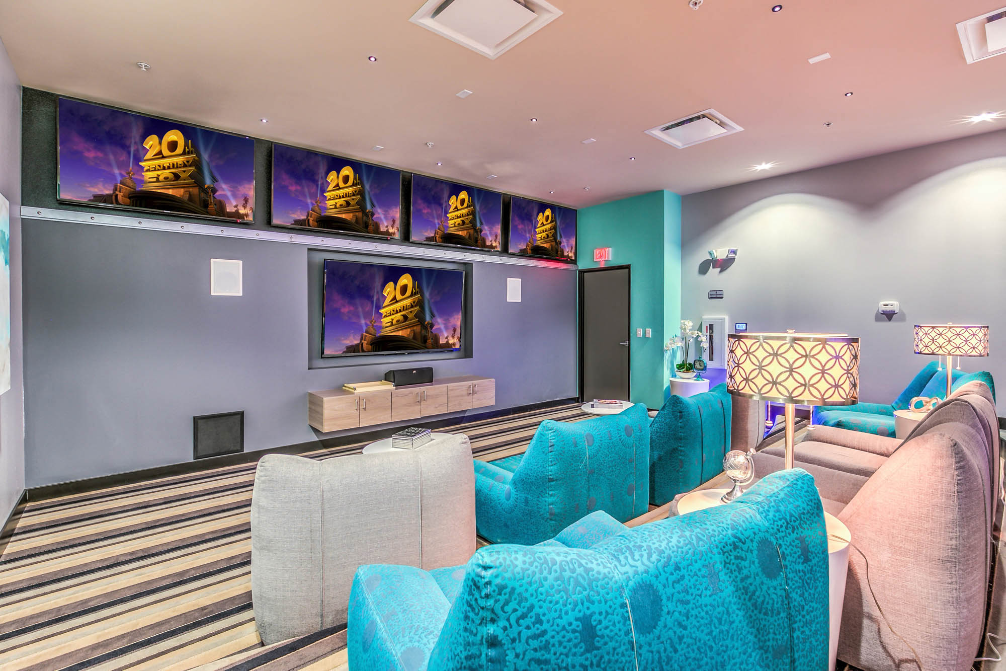 a living room with blue chairs and a television