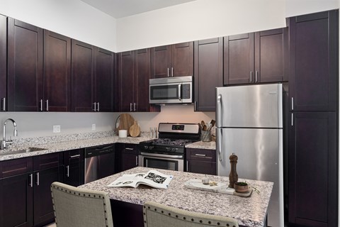 a kitchen with granite counter tops and stainless steel appliances
