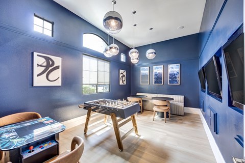 A blue room with a table and chairs.