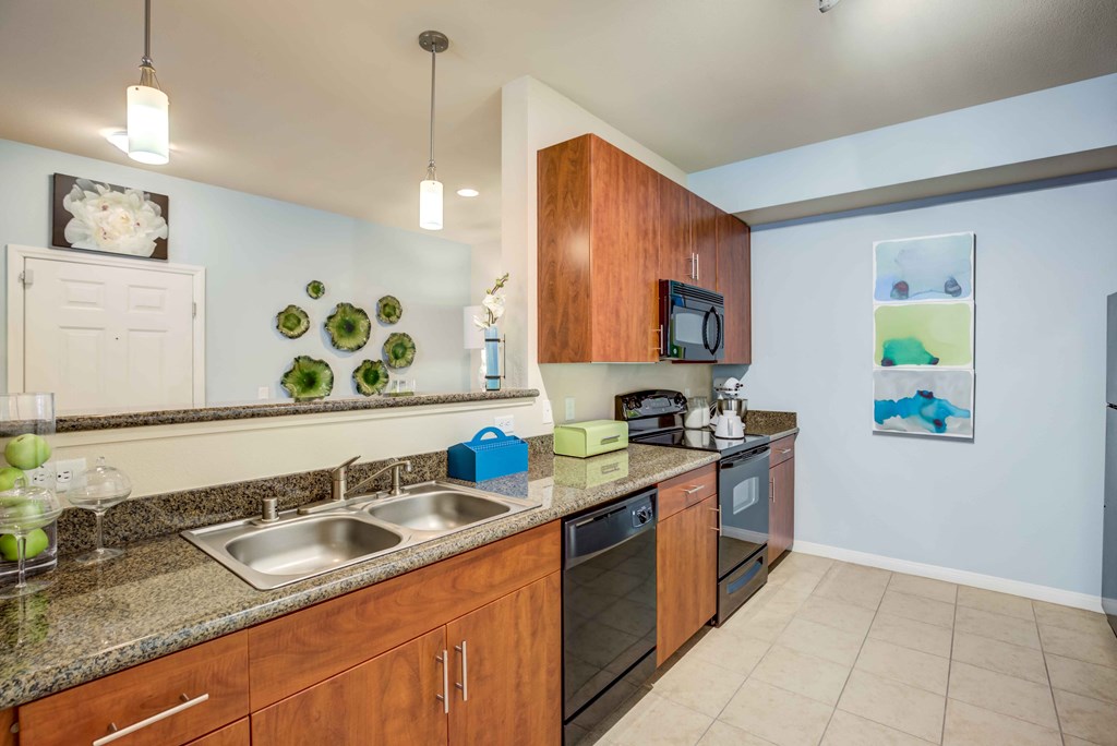 kitchen with double sink, oven, microwave