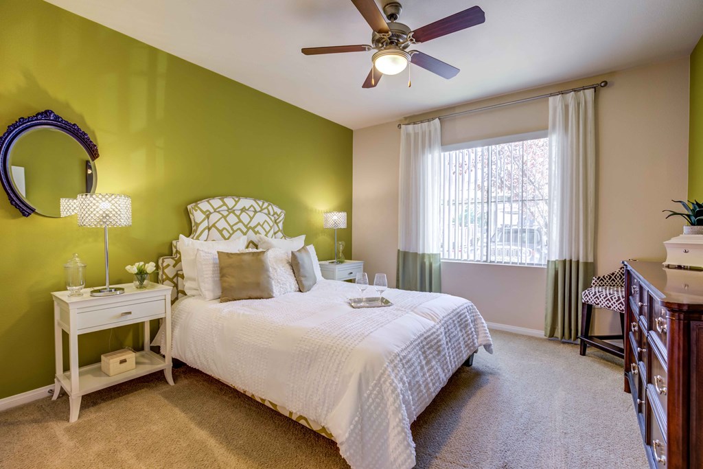 bedroom with large window and ceiling fan