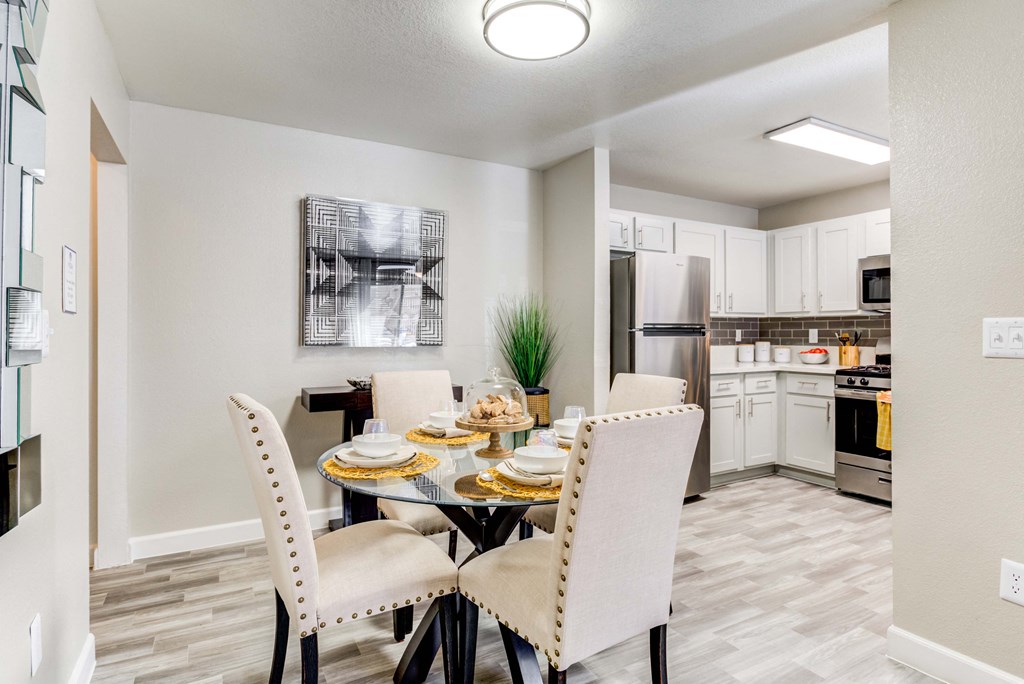 our modern kitchen and dining room are equipped with stainless steel appliances and a glass table