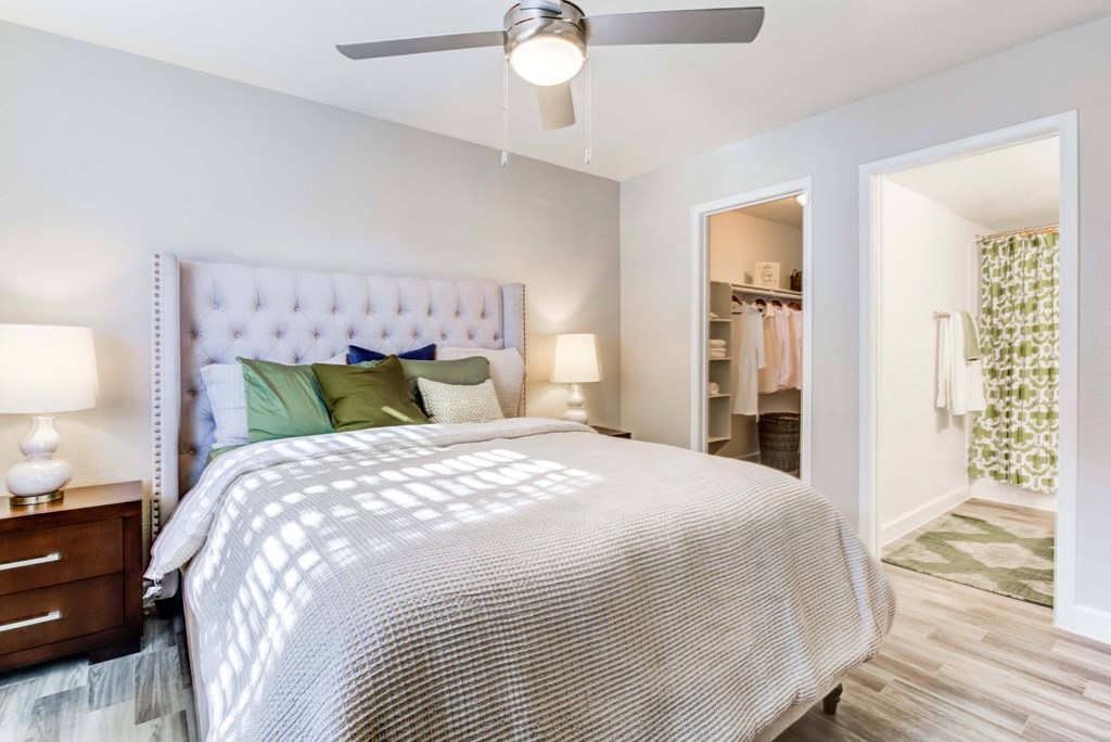 a bedroom with a bed and a ceiling fan