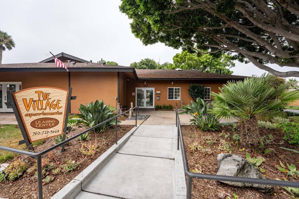 a brown building with a sign that reads the village