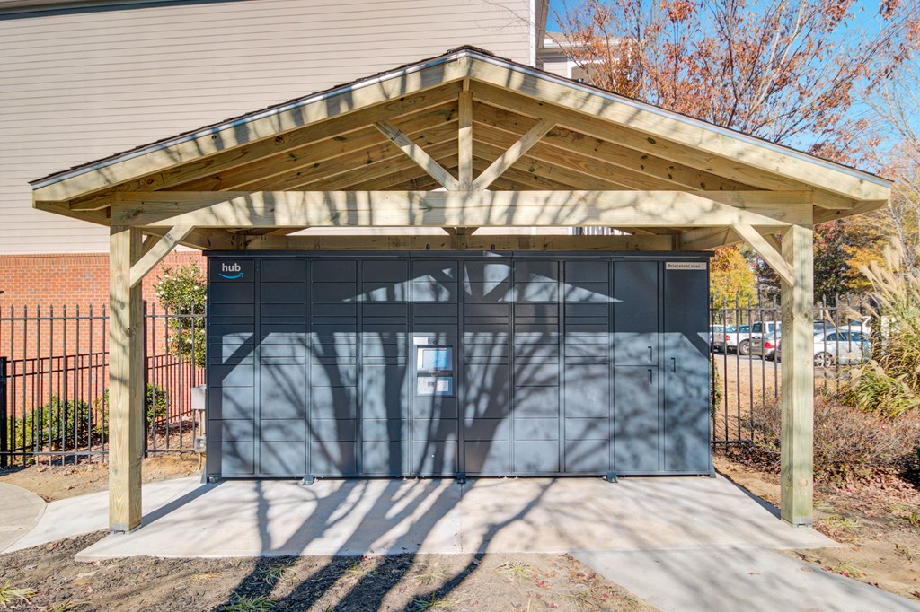 a garage with a black garage door and a wooden canopy