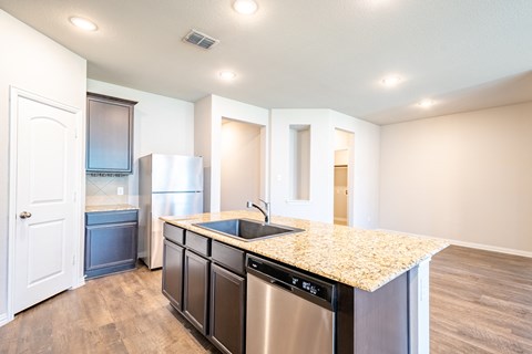 a kitchen with stainless steel appliances and a granite counter top