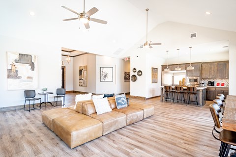a living room with a couch and a table and a kitchen