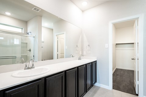 an empty bathroom with a large mirror and a sink