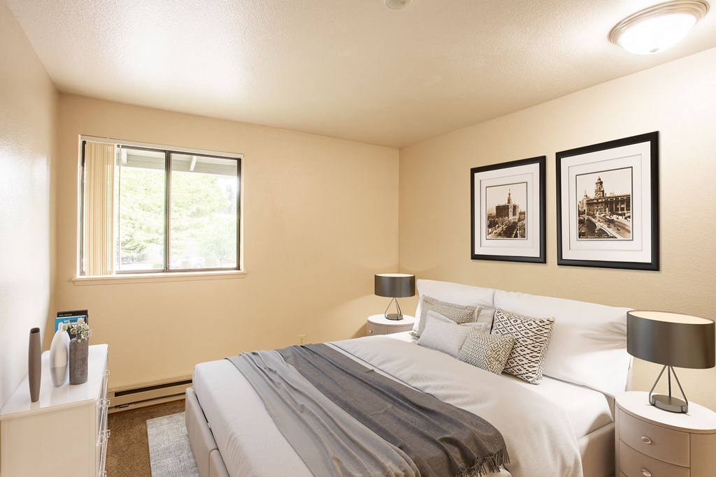 a bedroom with a bed and a window