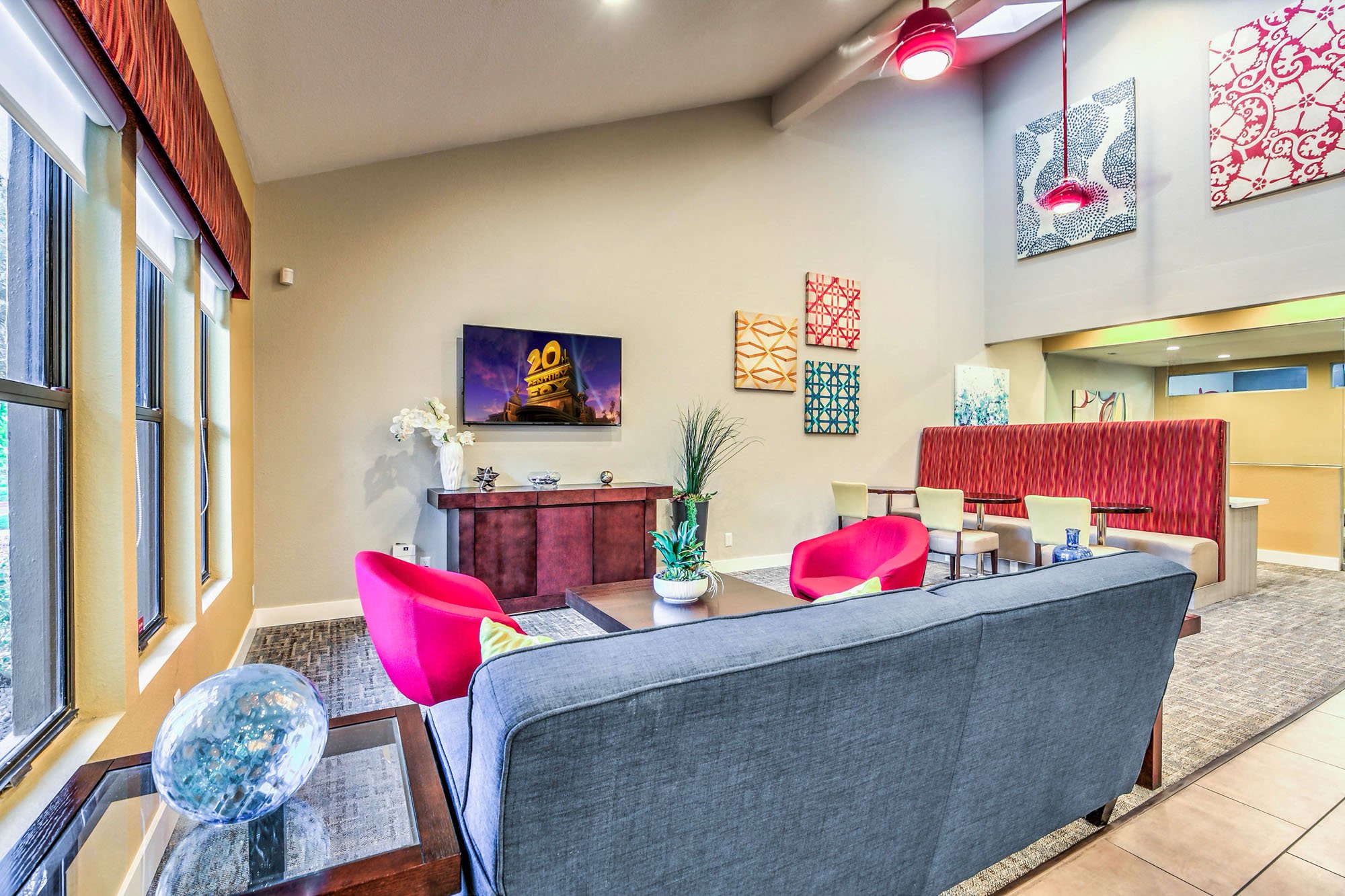 a living room with a couch and a table with chairs