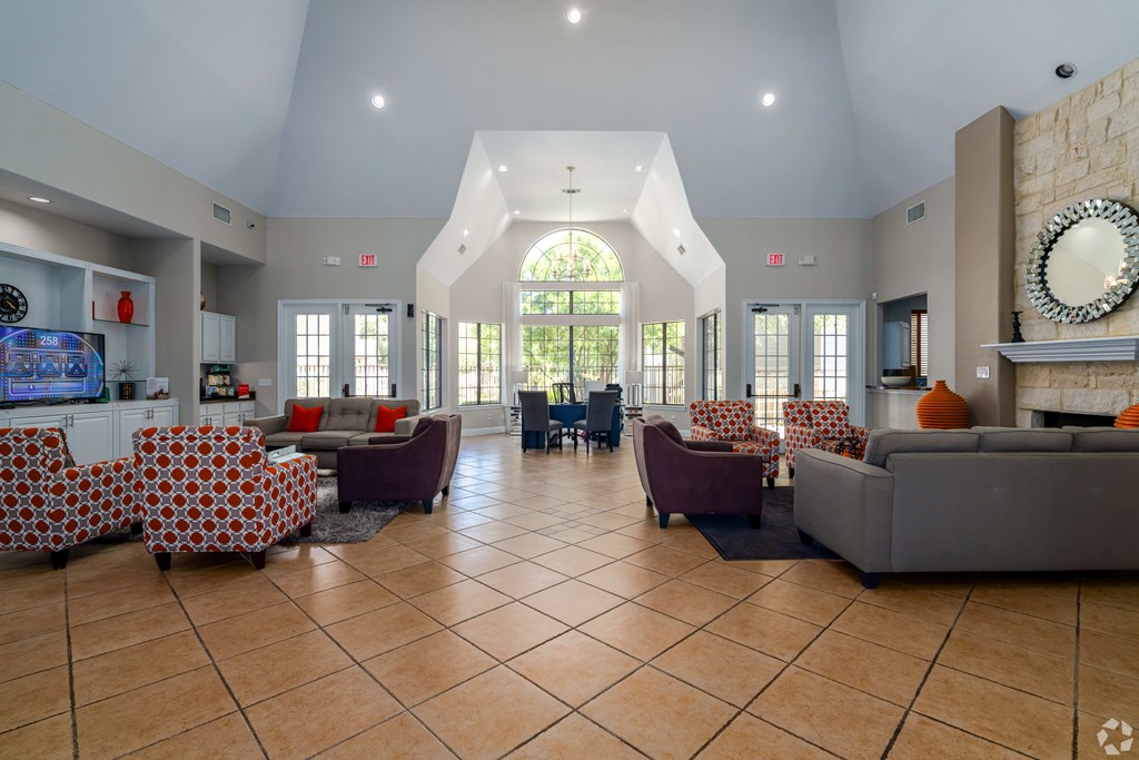 A spacious living room with a large window and a fireplace.