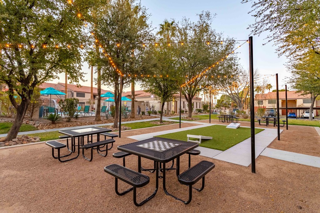 a picnic area with tables and benches in a park