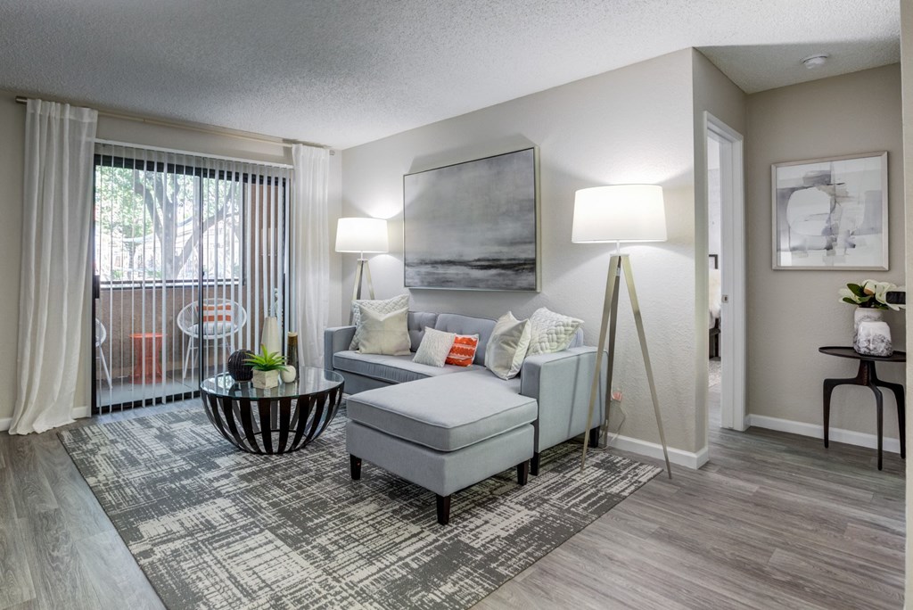 an open living room with a sliding glass door to a balcony