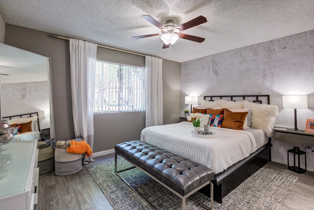 a bedroom with a large bed and a ceiling fan