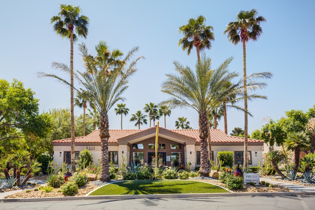 a building with palm trees in front of it
