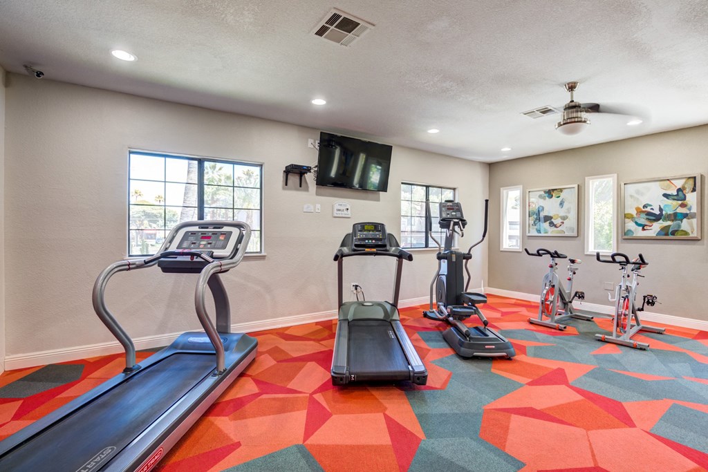 a gym with treadmills and other exercise equipment