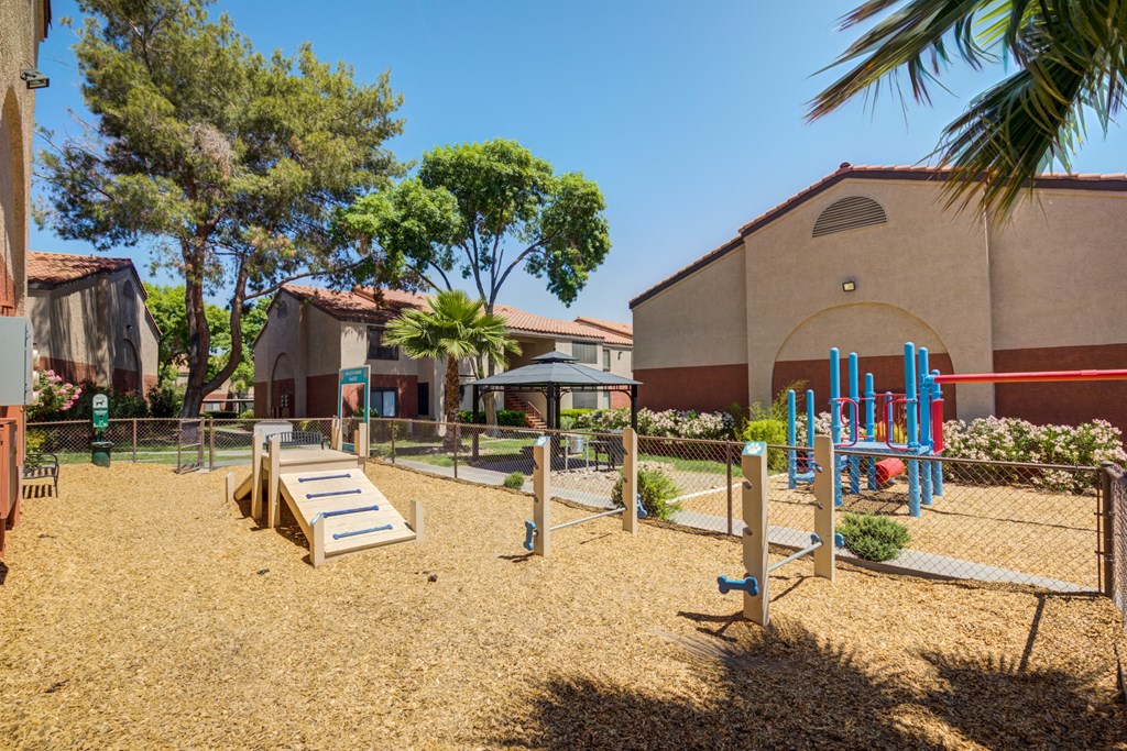 a playground with a pavilion and a building