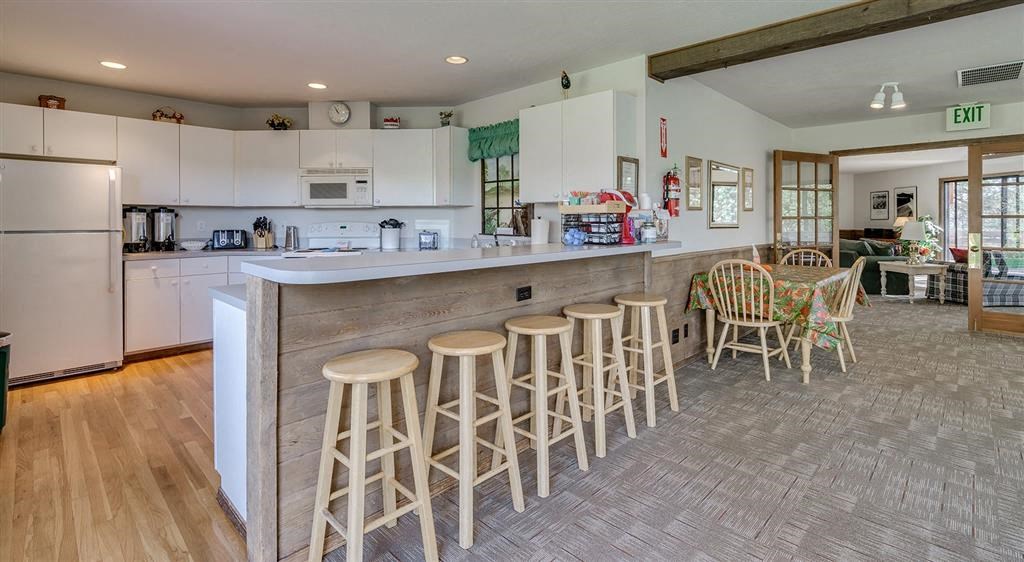 clubhouse kitchen with barstool and table seating