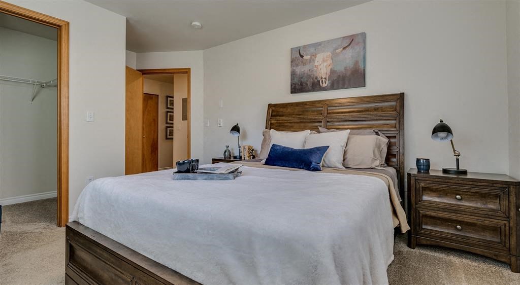 Apartments for Rent Spokane - Canyon Bluffs - Bedroom with Plush Carpet, a Bed, Nightstands, and a Spacious Closet