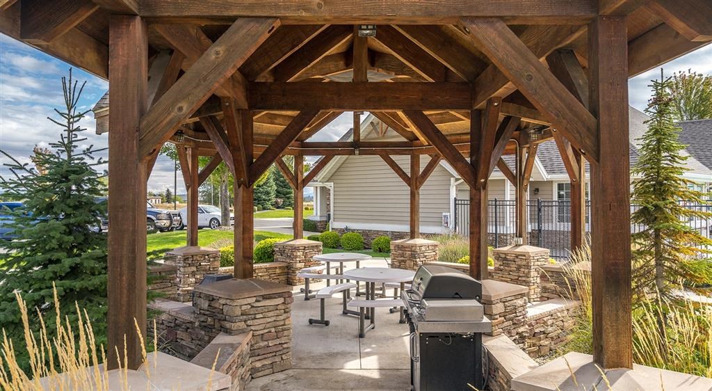 Apartments for Rent in Spokane WA - Deer Creek - BBQ Area with Grill, Seating Area, and Wooden Built-in Gazeebo