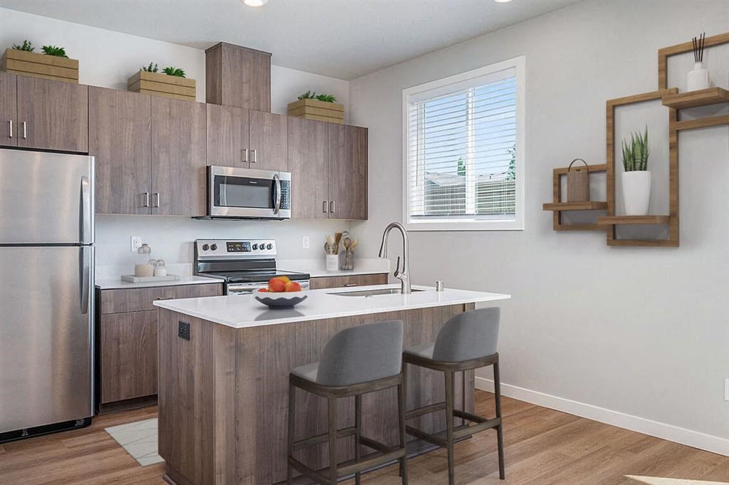 Four Bedroom Townhomes in Vancouver WA - Ridgeline View - Kitchen with Vinyl Plank Flooring, Stainless Steel Appliances, and Kitchen Island